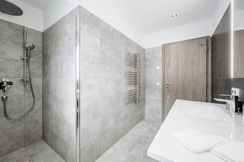 a bathroom with a shower and a sink at Alpenstern Panoramalodge in Damuls