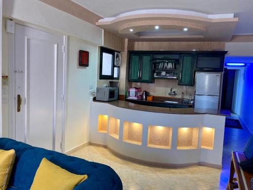 a kitchen with green cabinets and a blue counter top at Seaside Two-Bedroom Chalet Sidi Krir in Sidi Krir 