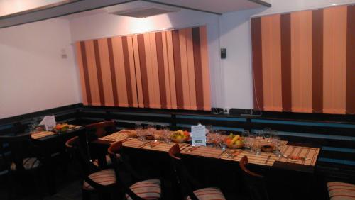 a dining room with two tables and chairs at Pensiunea Casa Maria in Buşteni
