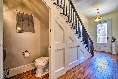 a bathroom with a toilet and a staircase at Historic Victorian Home 3 Mi to Churchill Downs! in Louisville