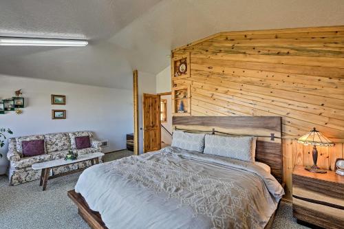 a bedroom with a large bed and a wooden wall at Sanderling Sea Cottages, Unit 10 in Waldport