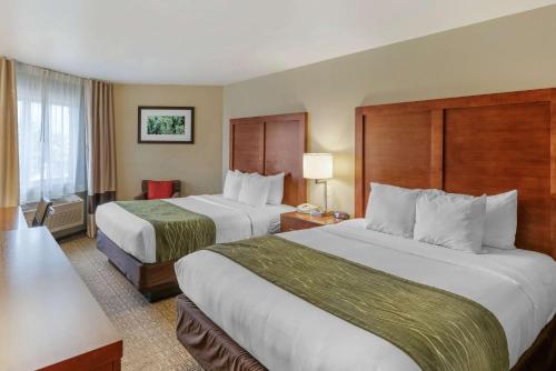 a hotel room with two beds and a window at Comfort Inn University in Missoula