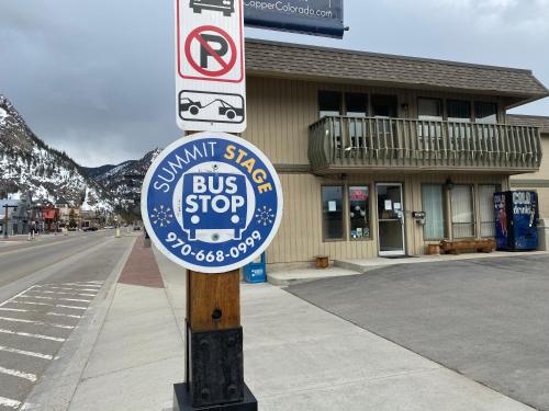 a bus stop sign on the side of a street at Snowshoe Motel in Frisco