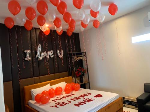 a room with a bed with red and white balloons at Biên Hòa Hotel in Bien Hoa
