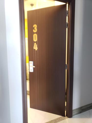 a brown door with the number three on it at Biên Hòa Hotel in Bien Hoa