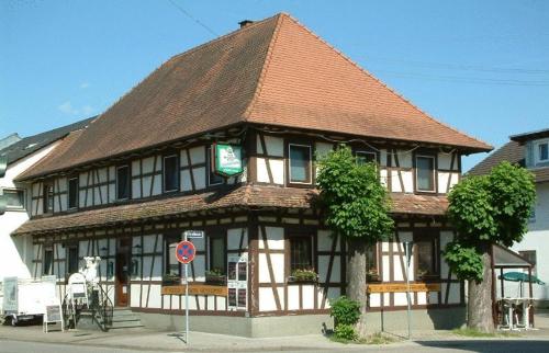a large building with a brown roof at Landgasthaus Kreuz beim Tom in Rastatt