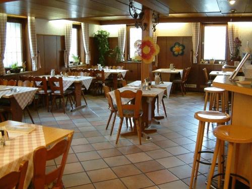 a dining room with tables and chairs and a restaurant at Landgasthaus Kreuz beim Tom in Rastatt