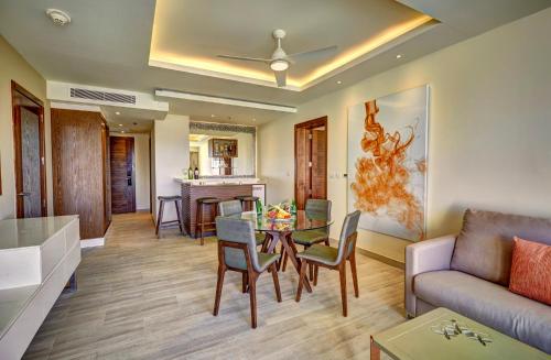 a living room with a table and a couch at Royalton Bavaro, An Autograph Collection All-Inclusive Resort & Casino in Punta Cana