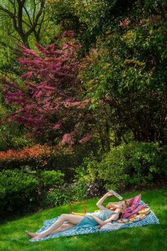 a woman laying on a blanket on the grass at Four Seasons Hotel Hangzhou at West Lake in Hangzhou