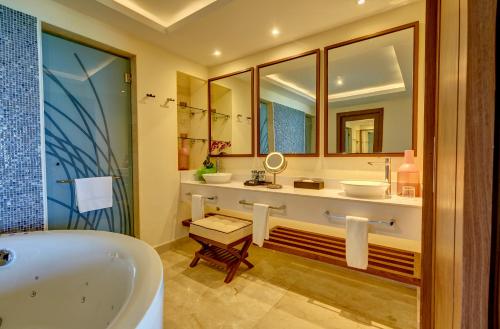 a bathroom with two sinks and a tub at Royalton Blue Waters Montego Bay, An Autograph Collection All-Inclusive Resort in Falmouth