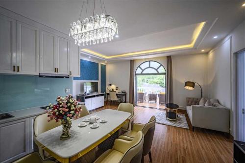 a kitchen and living room with a table and chairs at Seaside Boutique Resort Quy Nhon in Quy Nhon