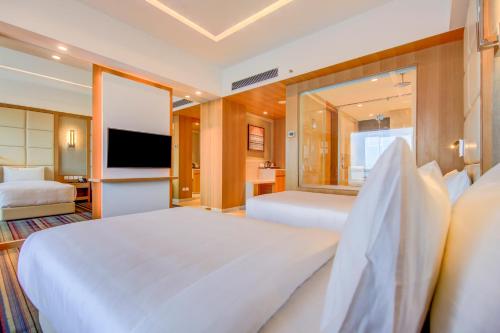 a hotel room with two beds and a television at Radisson Blu Gorakhpur in Gorakhpur