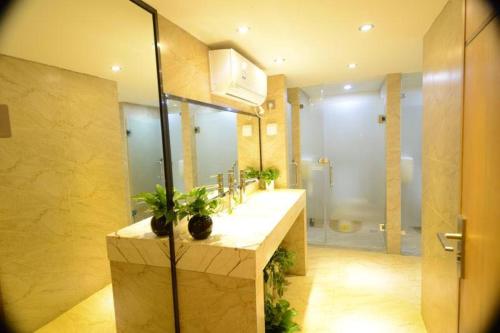 a bathroom with a sink and a shower at Boshan Hostel in Shenzhen