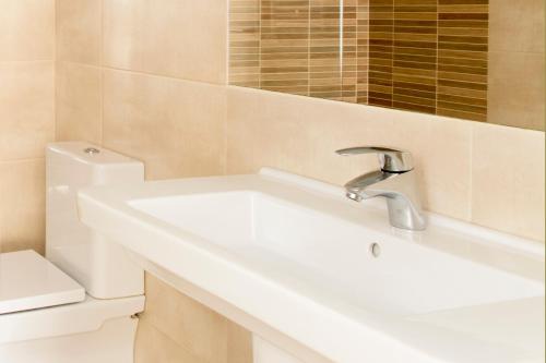 a bathroom with a sink and a toilet at Hotel Sauce in Zaragoza