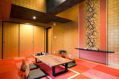 a dining room with a wooden table and chairs at Hana No Shizuku in Ureshino