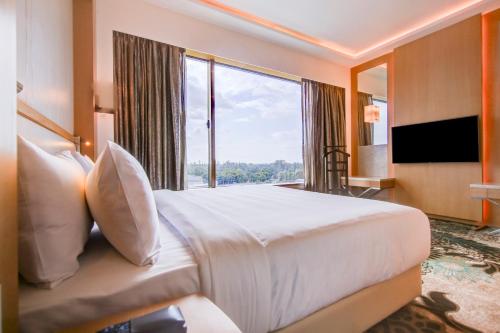 a bedroom with a large bed and a large window at Radisson Blu Gorakhpur in Gorakhpur