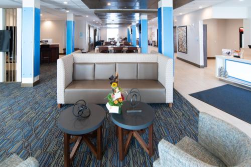 a lobby with a couch and two tables in a office at Holiday Inn Express & Suites - North Battleford by IHG in North Battleford