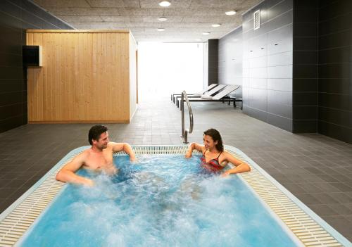 a man and a woman in a hot tub at PortAventura Hotel Caribe - Includes unlimited access to PortAventura Park & 1 access to Ferrari Land in Salou