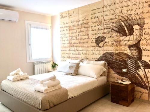 una camera da letto con un letto coperto di scrittura e un muro di Colibrì house a Sottomarina