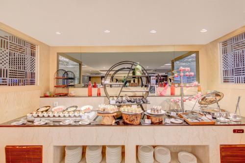 a buffet in a restaurant with food on a counter at Radisson Blu Gorakhpur in Gorakhpur