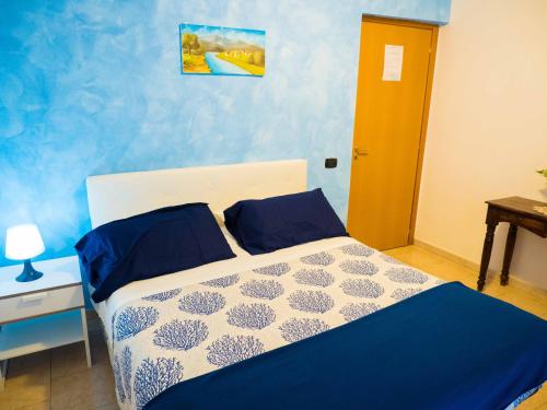 a bedroom with a bed with a blue wall at ALBERGO SANT'ANNA in Pagani