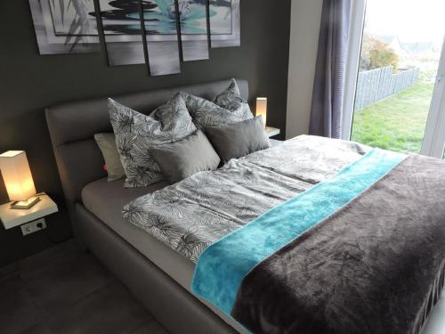 a bedroom with a bed with pillows and a window at Appartement - Haus Winterberg in Winterberg