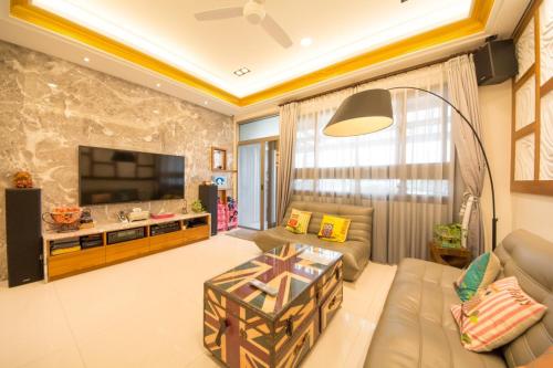a living room with a couch and a tv at Miller Homestay in Wujie
