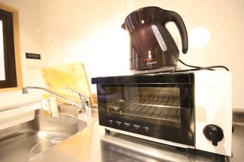 a coffee pot sitting on top of a microwave at Mibuan in Kyoto