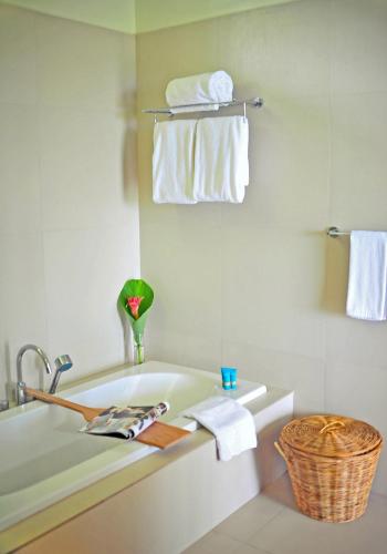 a bathroom with a bath tub and towels at Costa Pacifica Baler in Baler