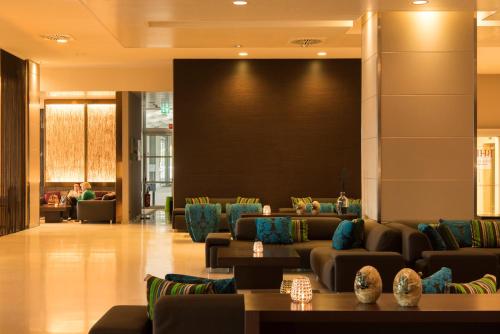 a lobby with couches and a large screen at Best Western Premier BHR Treviso Hotel in Quinto di Treviso