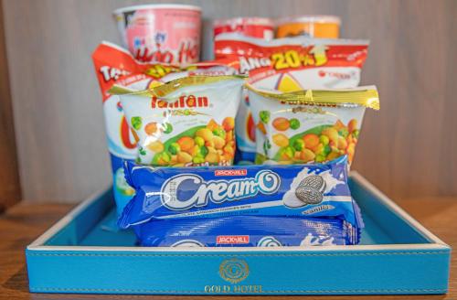 a blue container filled with different types of snacks at Gold Plaza Hotel Da Nang in Da Nang