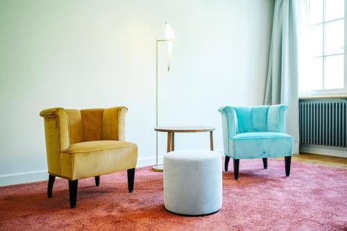 two chairs and a table in a room at Luxury Residences by Widder Hotel in Zürich