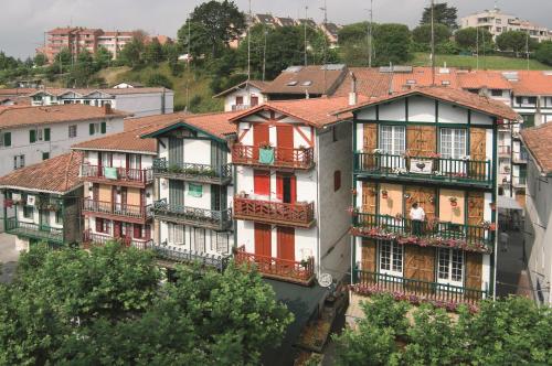 
a large building with a clock on the side of it at Sercotel Jauregui in Hondarribia
