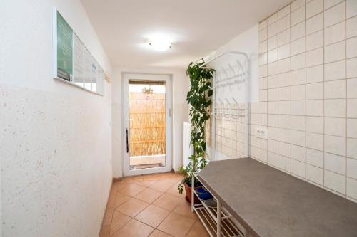 a bathroom with a plant on the wall at Apartment Stare in Bohinj