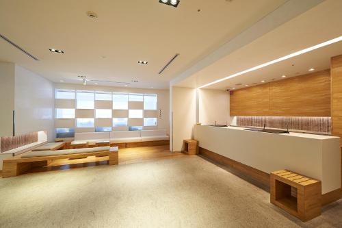 a large living room with a large window and a table at Sotetsu Fresa Inn Nagano-Zenkojiguchi in Nagano