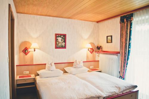 a bedroom with a bed with two pillows on it at Stan's Bed & Breakfast in Untergriesbach