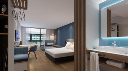 a hotel room with a bed and a bathroom at Holiday Inn Express Hangzhou Jiuzhou by IHG in Hangzhou