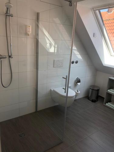 a bathroom with a toilet and a glass shower at Hotel Johann in Warendorf