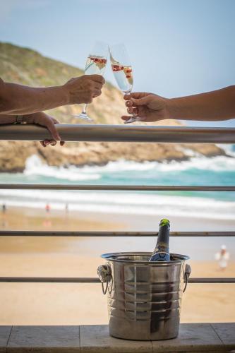 a group of people holding glasses of wine at Waves of Grace Seafront Villa in Herolds Bay