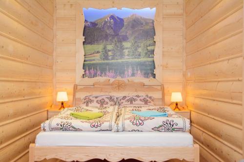a bedroom with a bed with a painting on the wall at Apartament Krupówki 36/8 in Zakopane
