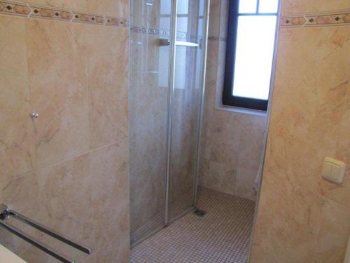 a shower with a glass door in a bathroom at Appartementanlage Urlaubsträume in Fulgen