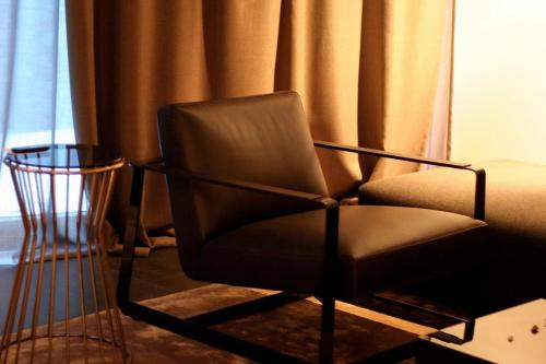 a black chair sitting in a room with a window at ON Chalet Residences Mathon-Ischgl in Mathon