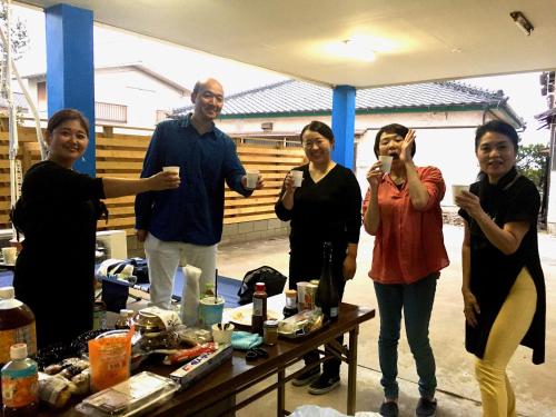 a group of people standing around a table at Oasis Wadaura in Minamiboso