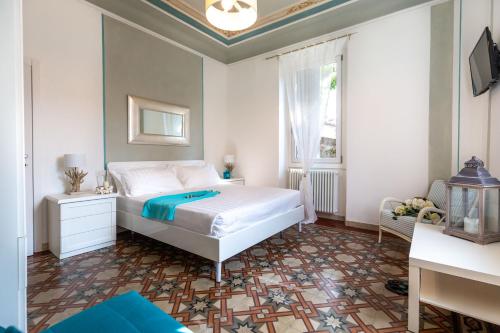 a bedroom with a white bed and a window at Maji Como Lake in Mandello del Lario