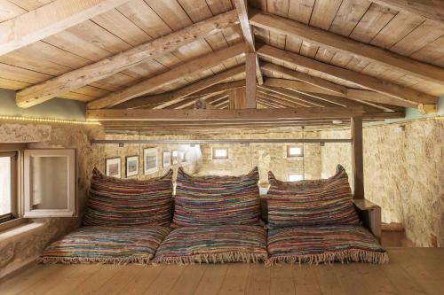 a large couch in a room with wooden ceilings at Mounty Island Villas-Nefeli in Lazaráta