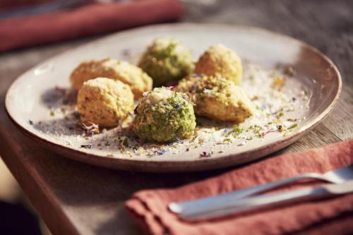 a plate of food with broccoli on a table at Hotel Brenner - Stop & Go in Vipiteno