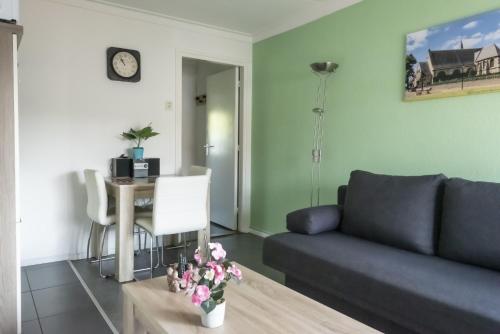 a living room with a couch and a table at Hermes Appartementen in Berg en Terblijt