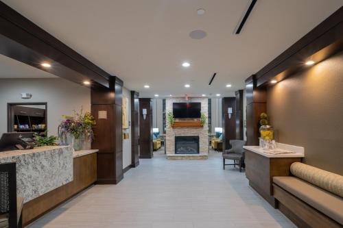 a lobby of a hotel with a fireplace at Staybridge Suites Houston East - Baytown by IHG in Baytown