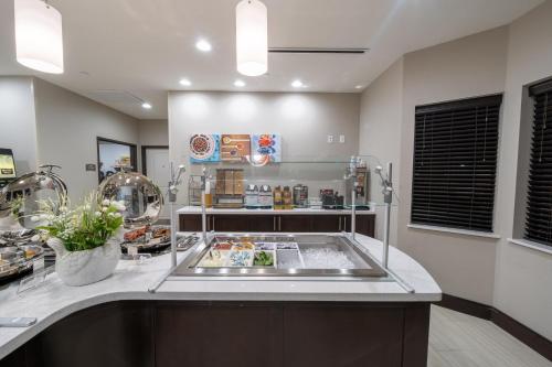 a kitchen with a sink and a counter top at Staybridge Suites Houston East - Baytown by IHG in Baytown