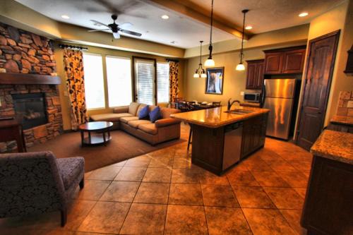 a kitchen and living room with a couch and a fireplace at Canyon Villas at Coral Ridge in Washington